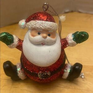 Festive sitting Santa Claus glitter Ornament. Perfect holiday decor